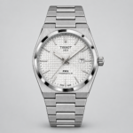 ساعة TISSOT PRX رجالي ستانلس ستيل بظهر شفاف ونافذة تاريخ